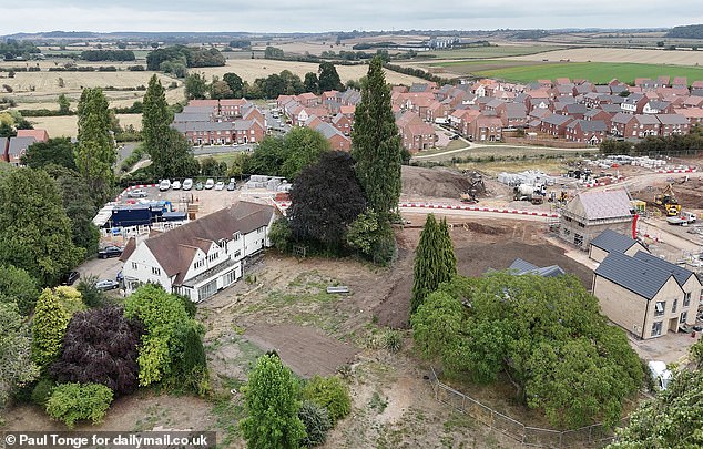 The white house is seen in the distance surrounded by newbuild properties