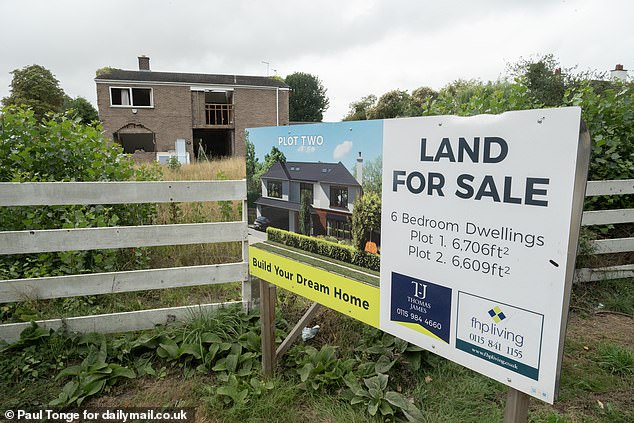 A 'land for sale' sign in the area where the abandoned mansion sits