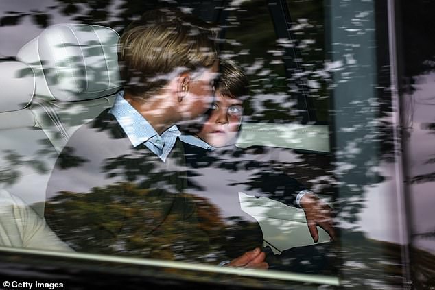 Princes George (left) and Louis appeared deep in conversation as Louis looked up at his older brother during the car journey