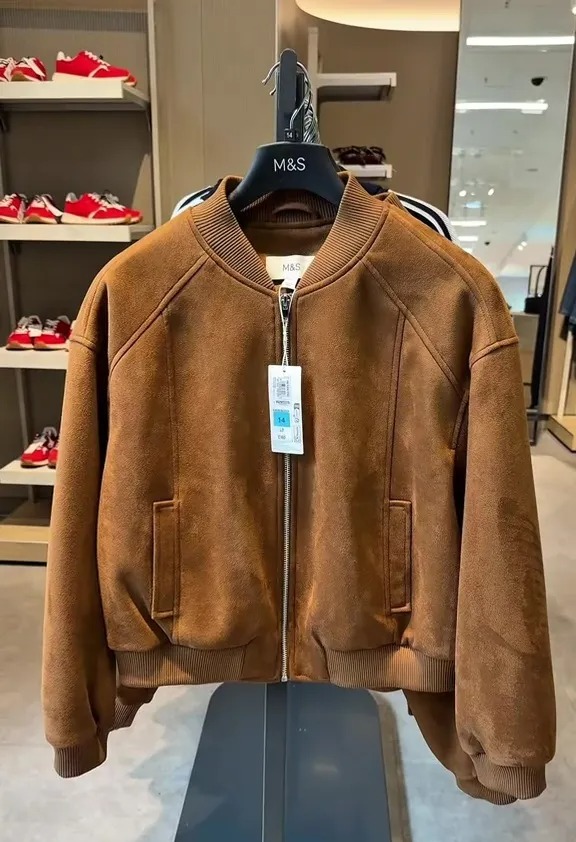 Brown suede bomber jacket on display.