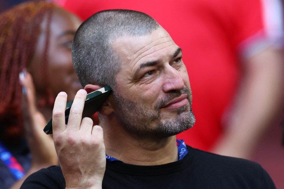 Mark Bellingham on his phone before a UEFA EURO 2024 match.