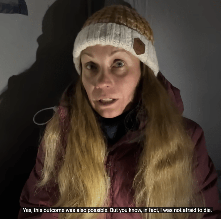 Woman speaking in a tent.