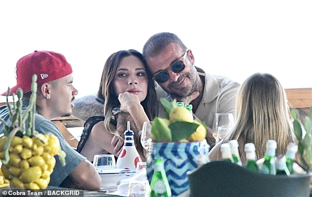 David rested his head on Victoria's with his arm over her shoulder