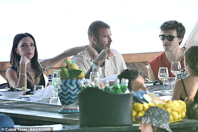 Victoria rested her arm on David's shoulder