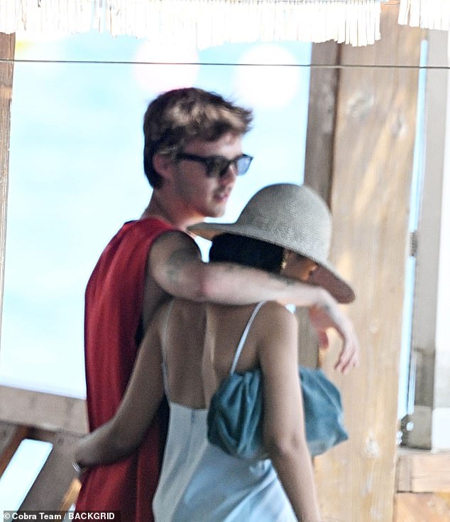 Cruz cut a casual figure in a red T-shirt and shades, while his glamorous girlfriend Jackie looked typically chic in a cream slip dress and sunhat
