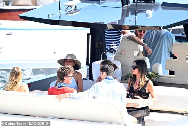Most of the family sat at the back of the boat on bench seating