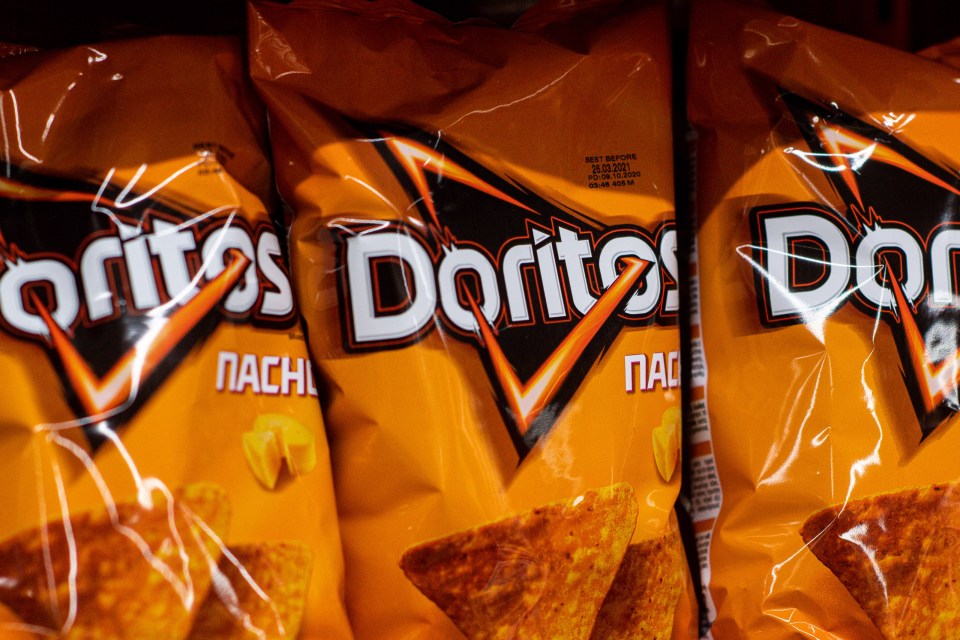 Doritos nacho cheese chip bags in a grocery store.