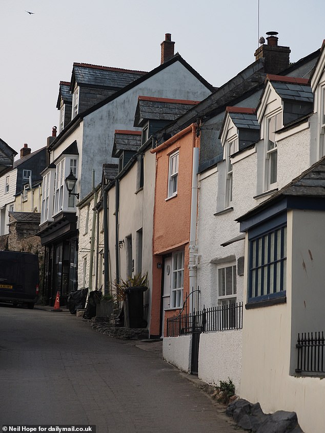 Locals say shoots in the village (pictured) for Pilcher films, Doc Martin and the Fisherman's Friends band 'just get in the way'