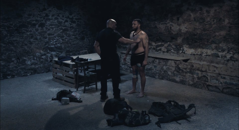 A man being interrogated in a dark room.