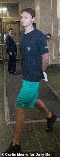 He sported the same outfit while being processed at NYPD's 10th Precinct