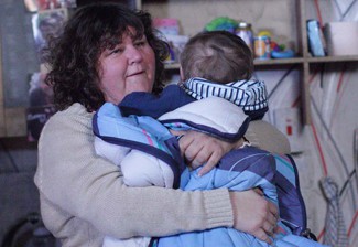 © BBC **EMBARGOED FOR PUBLICATION UNTIL TUESDAY 8TH FEBRUARY 2011**  Picture shows: Heather Trott (CHERYL FERGISON) and baby George TX: BBC ONE Tuesday 15th February 2011   Heather, exhausted in her freezing bedsit.