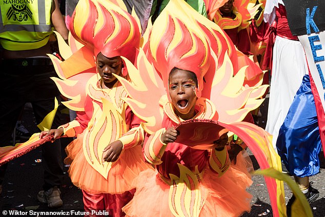 Young performers in colourful costumes take part in the Children's Parade today