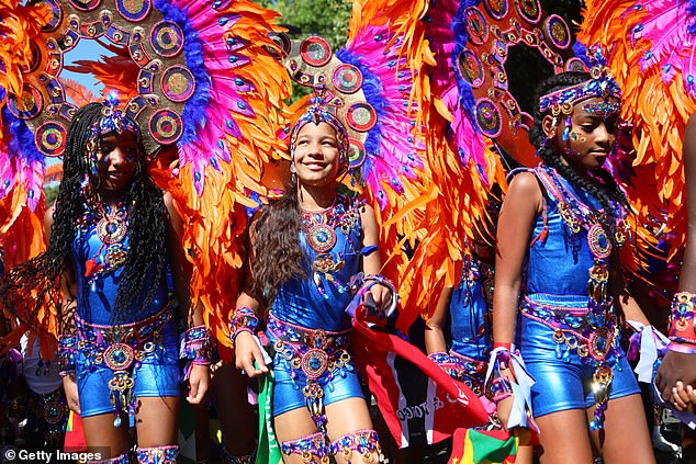 A group of girls dressed up in colourful costumes for Notting Hill carnival