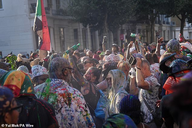 Carnival revellers dance in the streets on Sunday - the official launch of Notting Hill Carnival