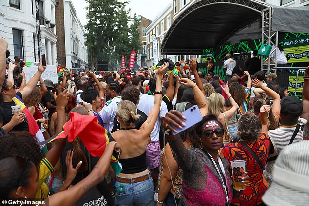 Revellers dance at a sound stage during the Carnival