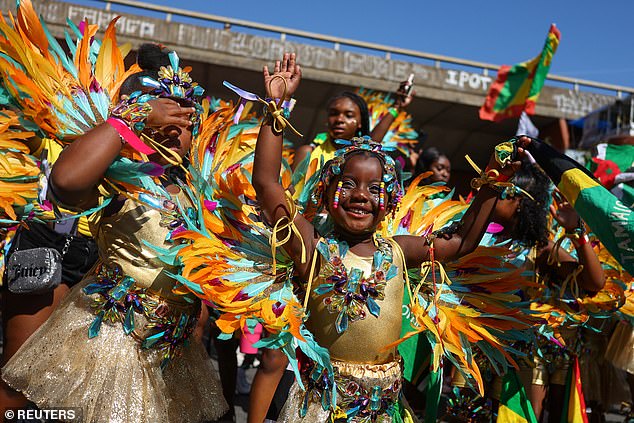 Children in Caribbean-themed costumes take part in the Children's Day Parade