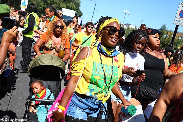 Revellers gather in the sunshine during the Notting Hill Carnival on August 24, 2025