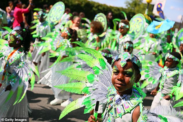 Young revellers in colourful costume take part in the Notting Hill Carnival