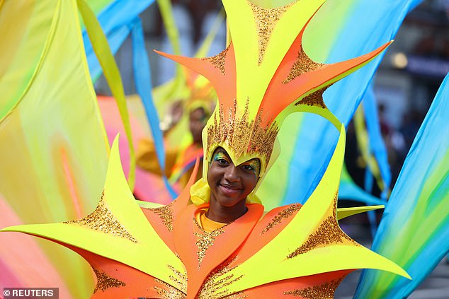 A participant in a pointy costume smiles for the camera during the carnival