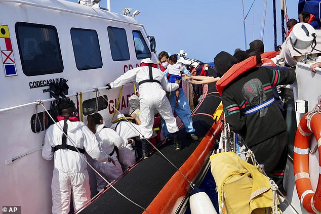 Italian Coast Guard personnel evacuate migrants from the vessel NADIR operated by the organization RESQSHIP
