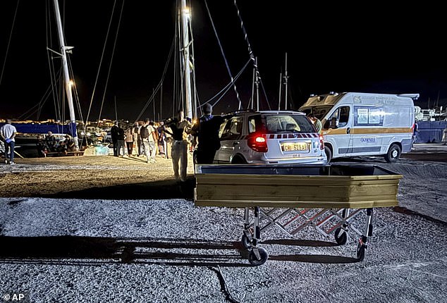 A coffin on the dock of the Sicilian island of Lampedusa, early Saturday, Aug. 23, 2025 as migrants that were rescued by the crew of the vessel NADIR operated by the organization RESQSHIP