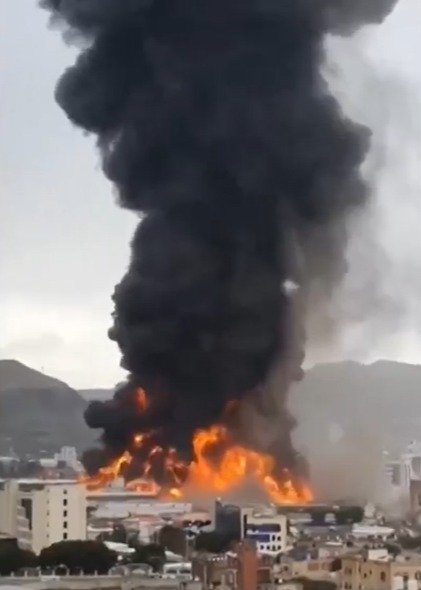 Large explosion and fire in a city.