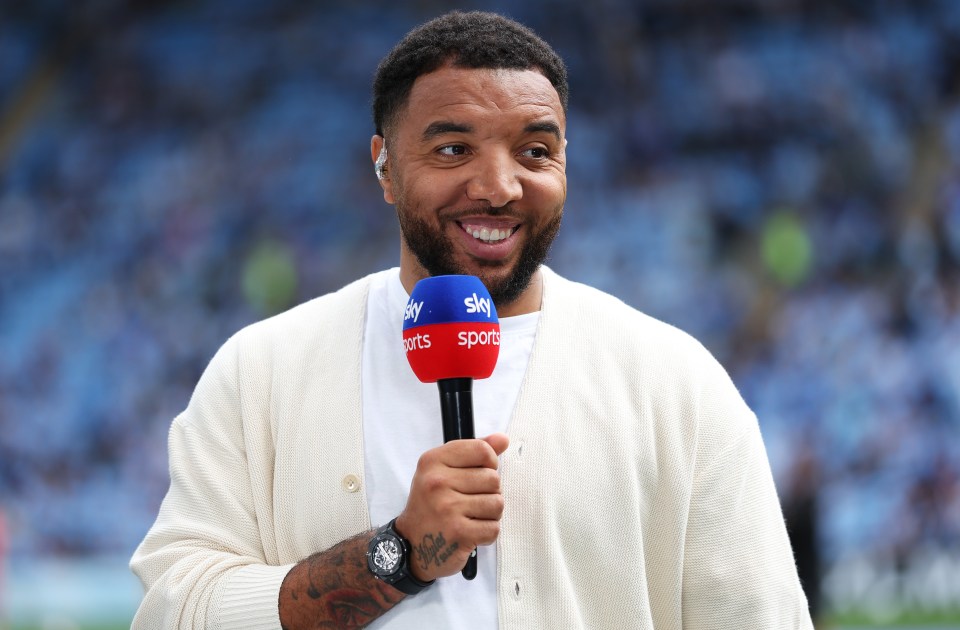 Troy Deeney holding a Sky Sports microphone.
