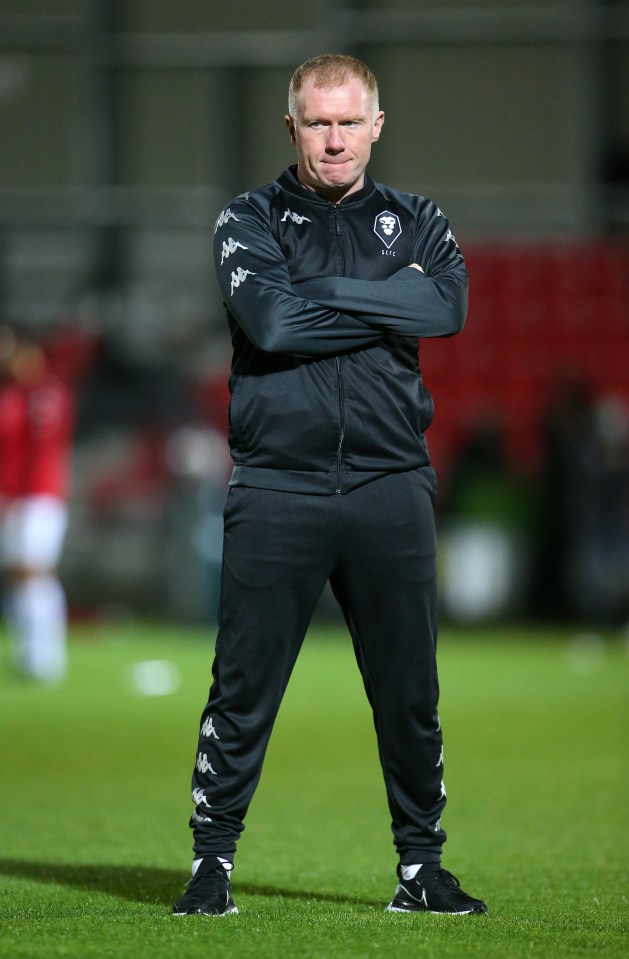 Paul Scholes, caretaker manager of Salford City, stands on the pitch.