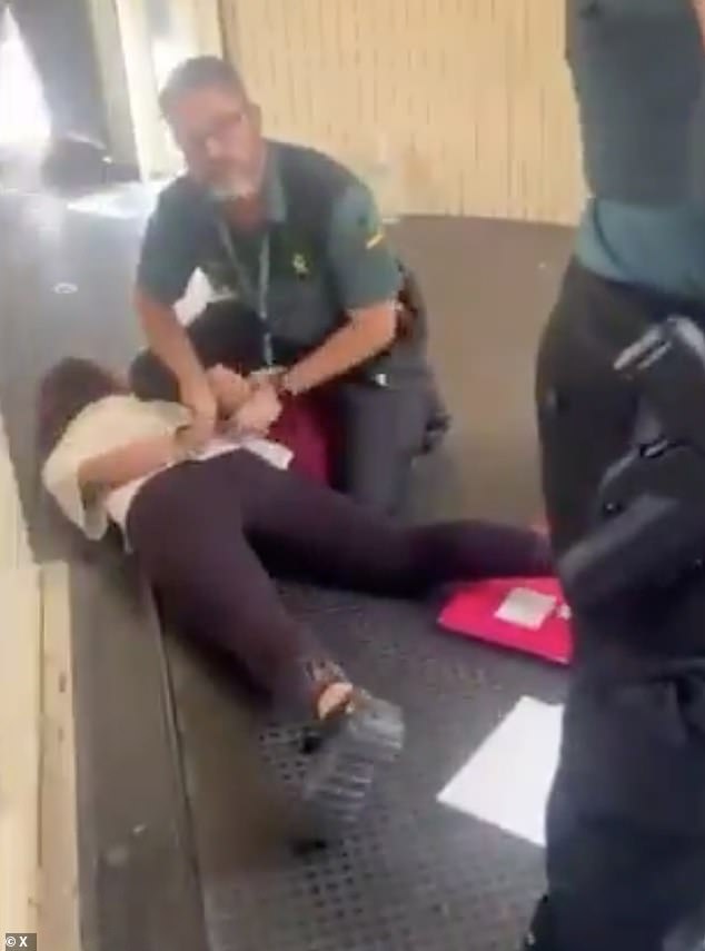 Footage shared online appeared to show one adult member of the group being detained by Spanish civil guard officers in the walkway shortly after she was removed from the jet