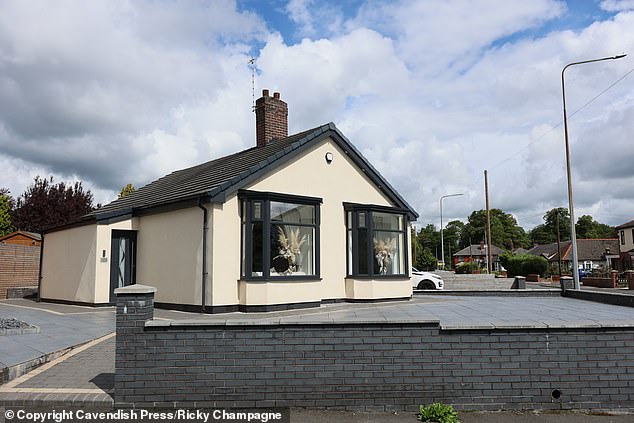 One woman questioned: 'Why would anyone get rid of that beautiful garden and replace it with concrete just to save parking outside the neighbour's house?'. Pictured: The home in Bolton