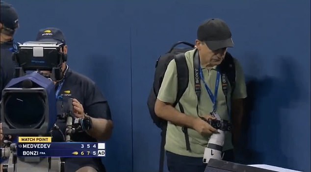 A photographer left his position and walked on to the court too early causing a disruption
