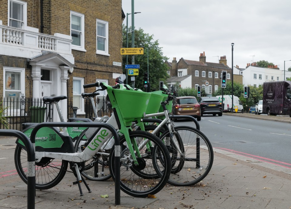 Lime bikes parked on a sidewalk.