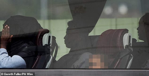 'I don't think a woman with a toddler can be considered a criminal', he reflected, adding migrants are not Britain's 'main problem' in the way many think they are. Pictured: A group of people thought to be migrants are driven away from the Border Force compound in Dover on August 12, 2025