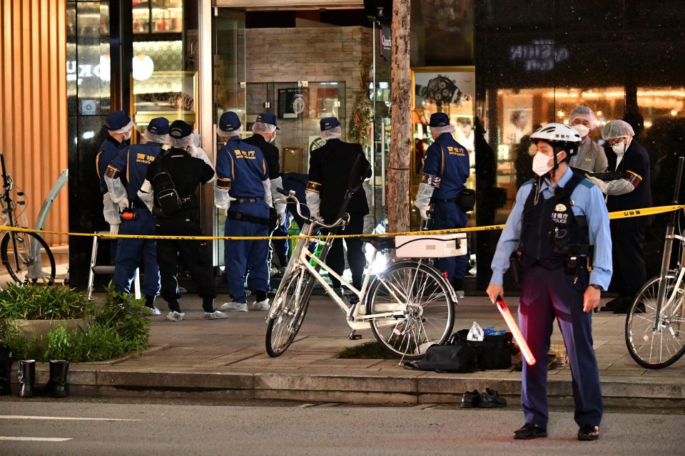 Police officers investigating a crime scene in Tokyo.