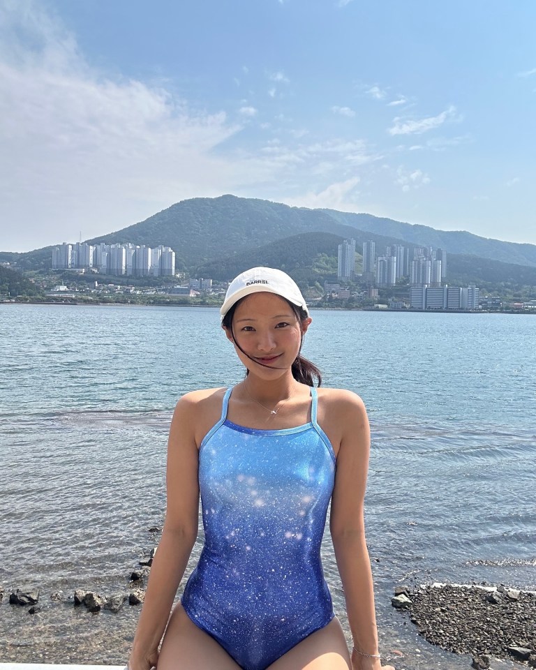Woman in a swimsuit by the sea.