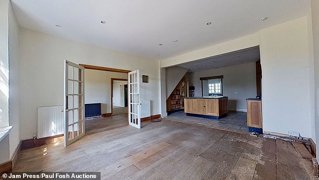 The entrance hall leads into a spacious open-plan kitchen and dining room with space for entertaining a number of guests