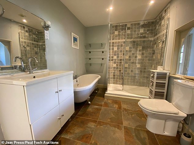 One of four bathrooms in the house with a separate bathtub and shower and suitable cupboard space