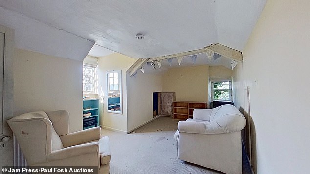 A small sitting room in the property with an armchair and sofa which could be used as a snug