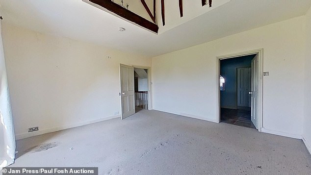 Exposed beams can be seen at the roof of one of the second floor bedrooms in the property