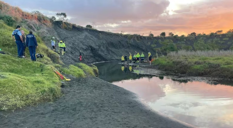 Emergency responders at a beach after a sand dune collapse.