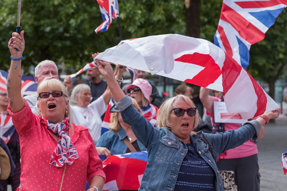 Anti-immigration protesters waving Union Jack flags in Newcastle upon Tyne.