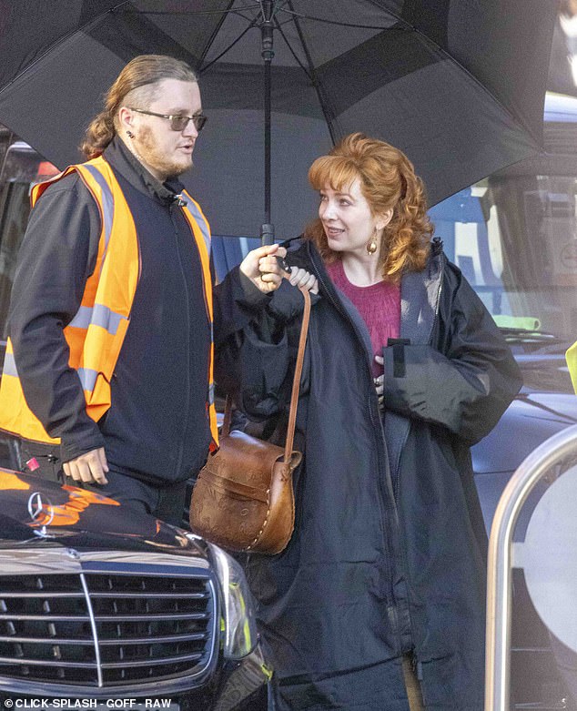 Katherine cheerily chatted with a member of the crew as she made her way to her mark