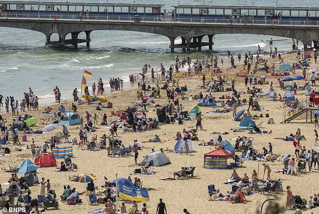 Thousands of people pack the beach in Bournemouth on Sunday as holidaymakers enjoy the scorching sunshine and cloudless blue skies