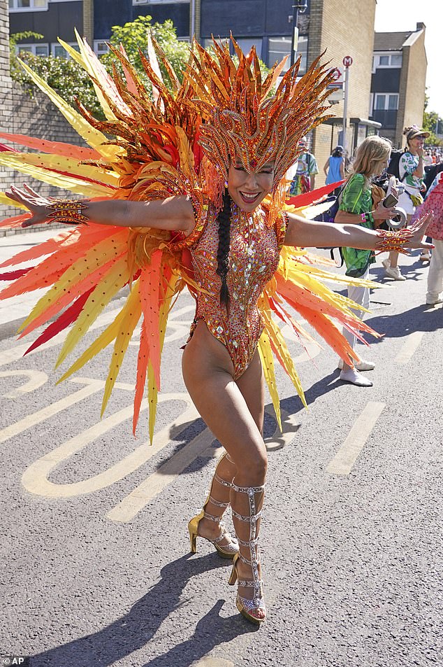 A costumed reveller arrives to take part in the parade later today