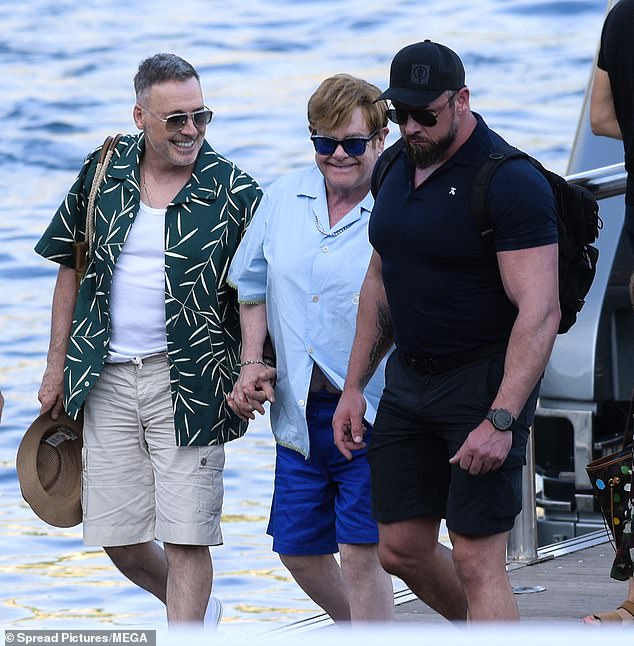 The Rocketman hitmaker showed off his laid-back sense of style in a pale blue shirt and matching shorts, while David opted for a bold shirt covered with a palm print