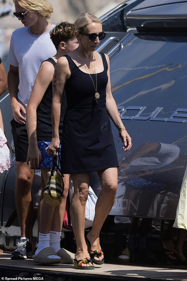 Sam cut a stylish figure in a black sundress and colourful wedges as she exited the yacht