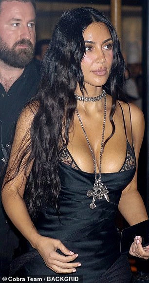 The daringly plunging look also teased a glimpse of her lace bra beneath