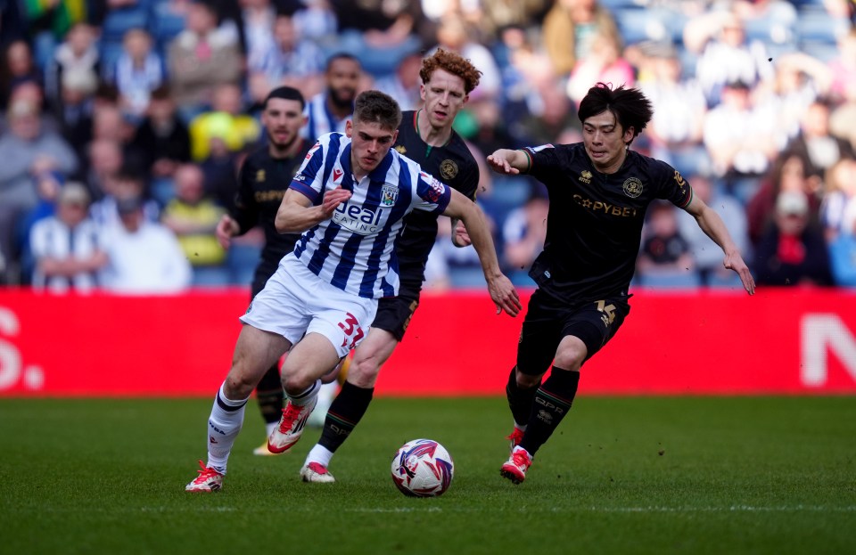 Two soccer players vying for the ball.