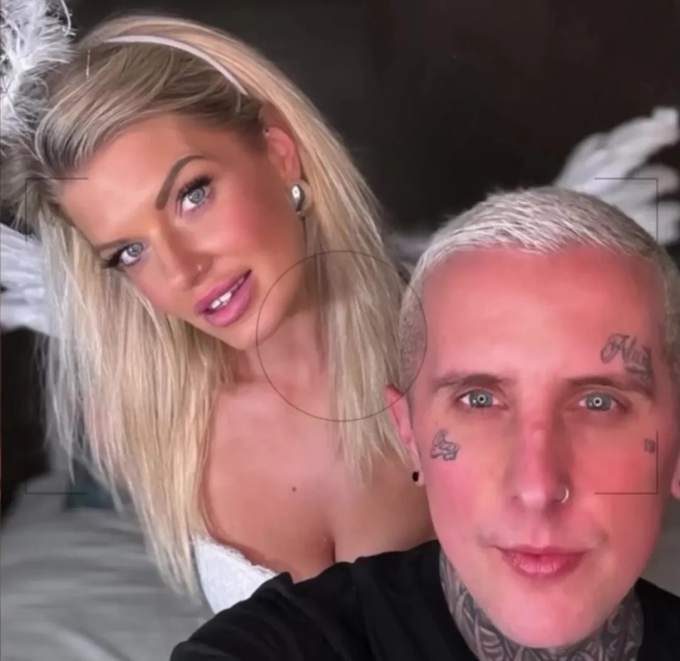 Photo of a man and woman posing together.  The woman is wearing an angel costume.