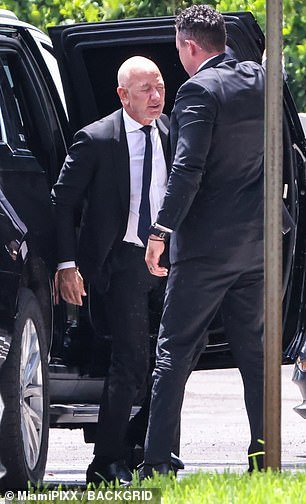 Bezos exited a black SUV as he arrived at the funeral home